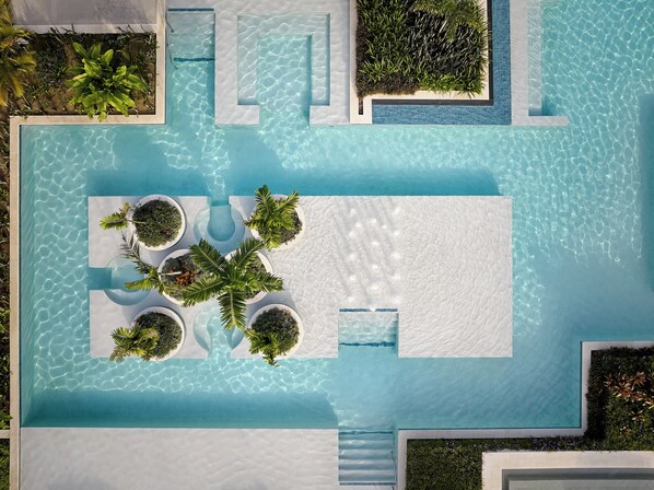 An aerial view of a swimming pool with multiple planters and a sunken seating area. - Crowne Plaza Fiji Nadi Bay Resort & Spa by IHG (Nadi)