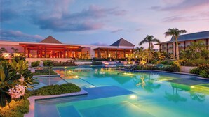 A resort with a large swimming pool, multiple buildings, and palm trees. - Crowne Plaza Fiji Nadi Bay Resort & Spa by IHG (Nadi)