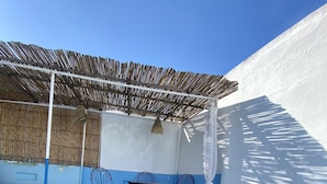 A covered outdoor area with a pool, seating, and a bamboo ceiling. - Dar Coeur De Tanger (Tangier)
