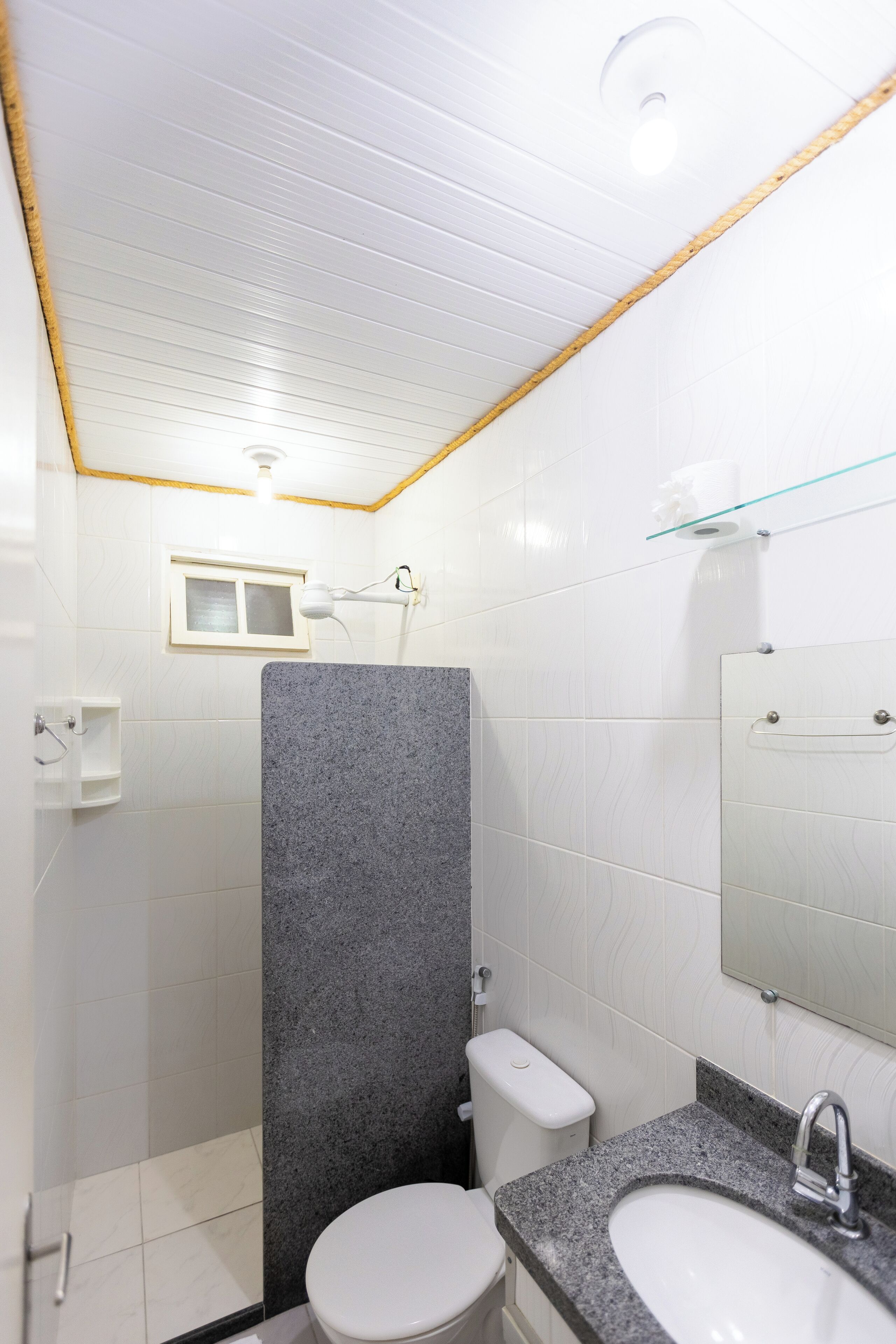 A modern bathroom with a shower, toilet, and two sinks.