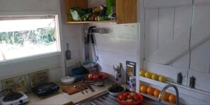 Full-sized fridge, cookware/dishes/utensils, cleaning supplies, freezer