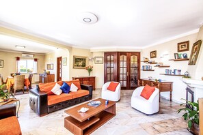 A spacious living room with a sofa set, a coffee table, and a fireplace. - Relax villa with BBQ and heatable pool (Carvoeiro)