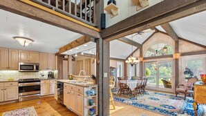 A spacious kitchen with wooden cabinets, stainless steel appliances, and a large island.