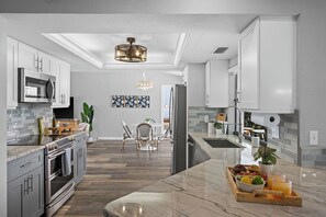 Enjoy cooking in this well-lit kitchen with a central island and breakfast tray.