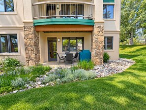 A two-story building with a covered patio area featuring outdoor furniture. -  Modern Mountain Retreat - Ski-in-out - Heated Pool and Hot Tub (Steamboat Springs)