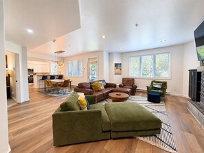 A spacious living area with a sectional sofa, a coffee table, and a fireplace.