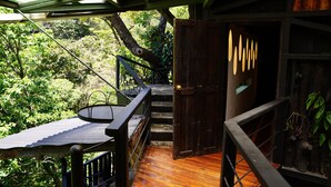 A wooden staircase leading to a deck with a metal railing, surrounded by lush greenery. - TreeTop House Getaway, Fairy Magic Rustic Elegance in the Cloud Forest, 3 Levels (Monteverde)