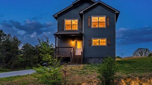 A two-story house with a porch, a staircase, and a driveway. - Smokies Cabin: Dog-Friendly, Hot Tub & Arcade Game (Sevierville)