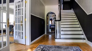 A staircase with black railings and white steps, leading to a landing with a door. - Riverfront Getaway (Two Rivers)