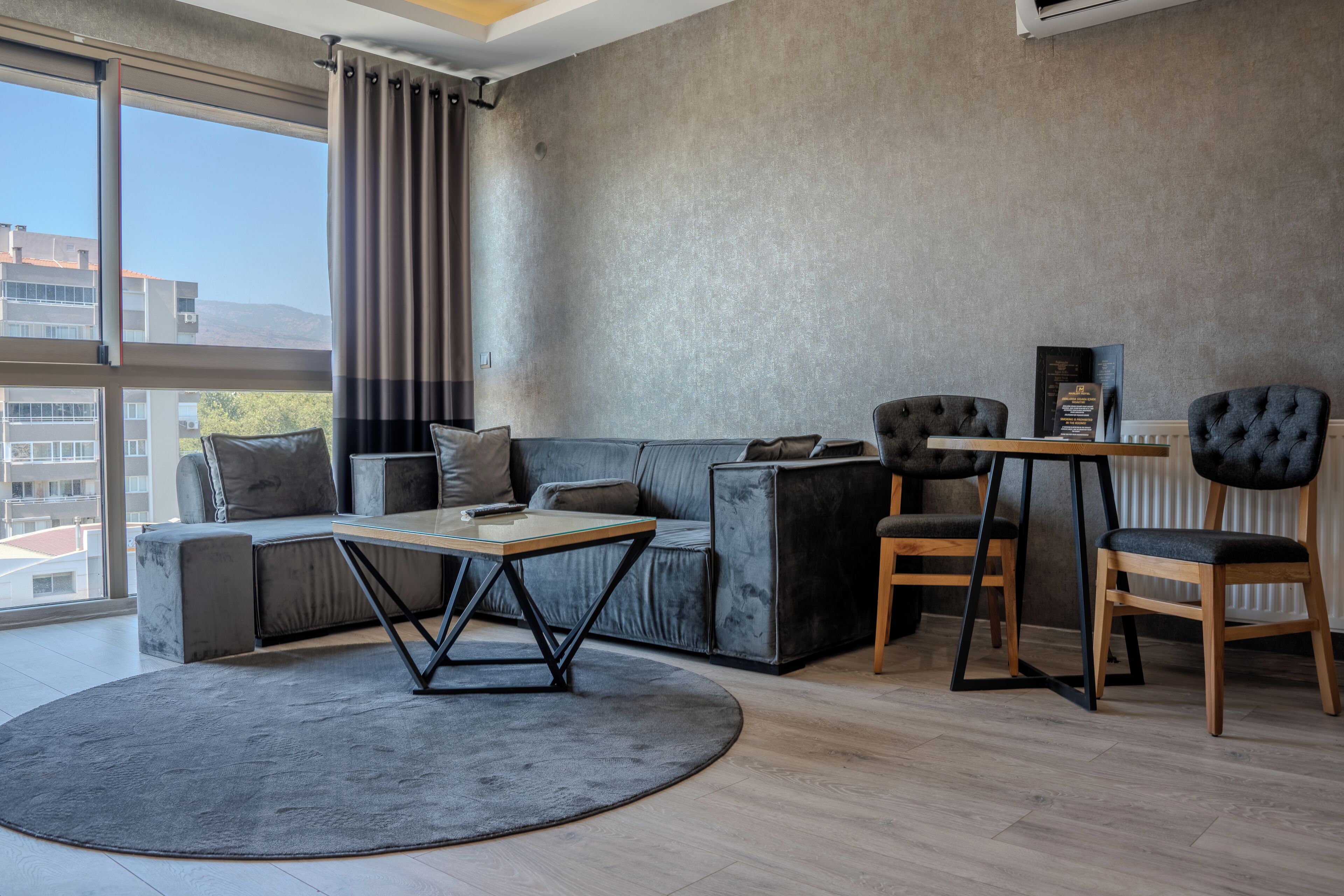 A modern living room with a sofa, a coffee table, and two chairs.