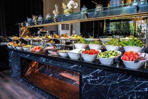 A buffet with various food items and a marble countertop. - Marlen Hotel Bayrakli (Izmir)