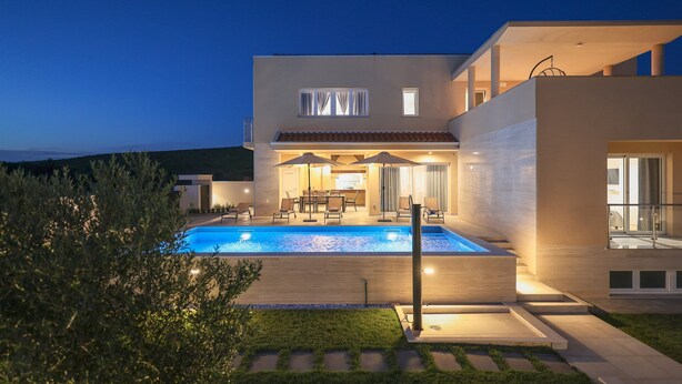 A modern two-story house with a swimming pool, outdoor seating, and a well-lit patio area. - Villa Morella with Heated Pool (Sukošan)