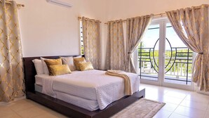 A bedroom with a bed, curtains, and a view of the outdoors. - Sienna is Private, Tranquil,  and Perfectly Located near Shoal Bay Beach! (Shoal Bay)