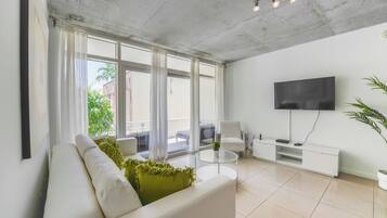 Deluxe Apartment | Living area | 50-inch Smart TV with cable channels