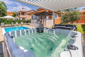 A swimming pool with a hot tub, outdoor seating, and a covered patio area. - Villa Lotus 13F with private pool and jacuzzi. (Pula)