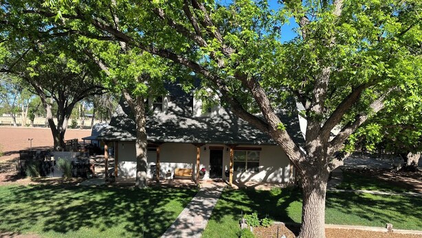A house with a covered patio, a lawn, and a tree in front. - Little Bird Casita: Have the Experience the New Mexico Traveler Hopes to Find. (Albuquerque)
