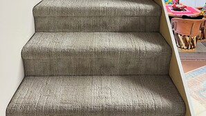 A staircase with a textured carpet, leading to a room with a kitchen area visible. - Little Bird Casita: Have the Experience the New Mexico Traveler Hopes to Find. (Albuquerque)