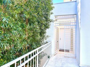 entrance to a secluded area, flanked by lush foliage.