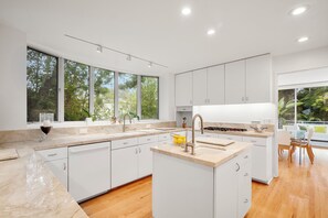 Enjoy meals in this kitchen with a central island, large window, and dining area.