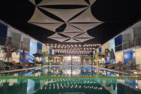2 outdoor pools, open 7:00 AM to 10:00 PM, pool loungers. Casa Blu Hotel & Resort
