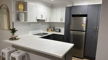 Coffee/tea maker, fridge, microwave, oven