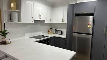Coffee/tea maker, fridge, microwave, oven