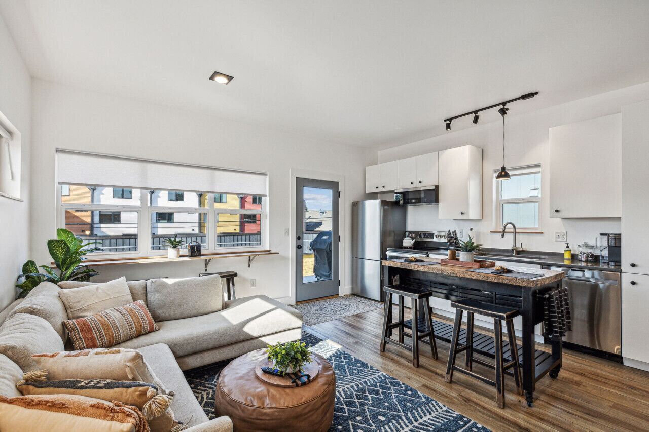 A modern apartment with a living room, kitchen, and dining area.