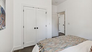 A bedroom with a bed, a wardrobe, and a door leading to another room. - * * * * *Modern Missoula Bungalow* * * * * (Missoula)