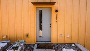 A building entrance with a door, a mailbox, and a number '1854' on the wall. - * * * * *Modern Missoula Bungalow* * * * * (Missoula)