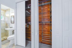 A bathroom with a toilet, sink, and shower. - Discover Serenity in this Tranquil Miami Home (Miami)