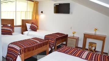 A hotel room with two beds, a TV, a wooden desk, and a small stool.