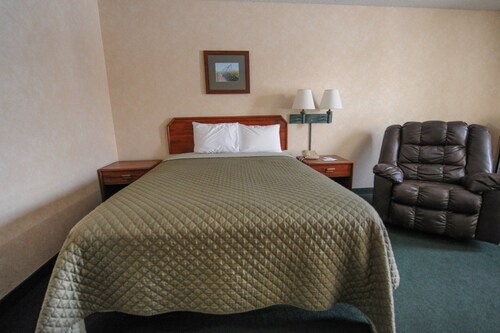 Hotel room with ONE QUEEN BED and attached, private bathroom. 