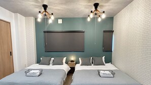 A double room with two beds, a large wall-mounted TV, and a ceiling light fixture. - Deep Osaka! A Running Lamp 2 minutes from the station! Ideal location for sightseeing in Namba & USJ Osaka! Up to 6 people are allowed at the same price (大阪市)