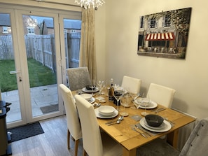 Enjoy formal dining for six in this elegant space, complete with a table set and wine.