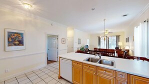 A kitchen with a white countertop, wooden cabinets, and a dishwasher. - Four Bedroom, 3 Baths, Avian Forest, Scenic View (Pawleys Island)