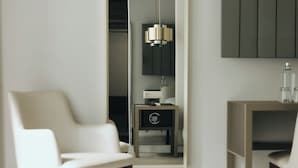 A modern room with a large mirror, a white chair, a wooden side table, and a hanging pendant light. - M’AR De AR Auria (Lisbon)