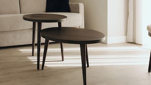 A minimalist living room with a sofa and two round tables. - M’AR De AR Auria (Lisbon)
