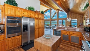 A spacious kitchen with wooden cabinets, stainless steel appliances, and a large island.