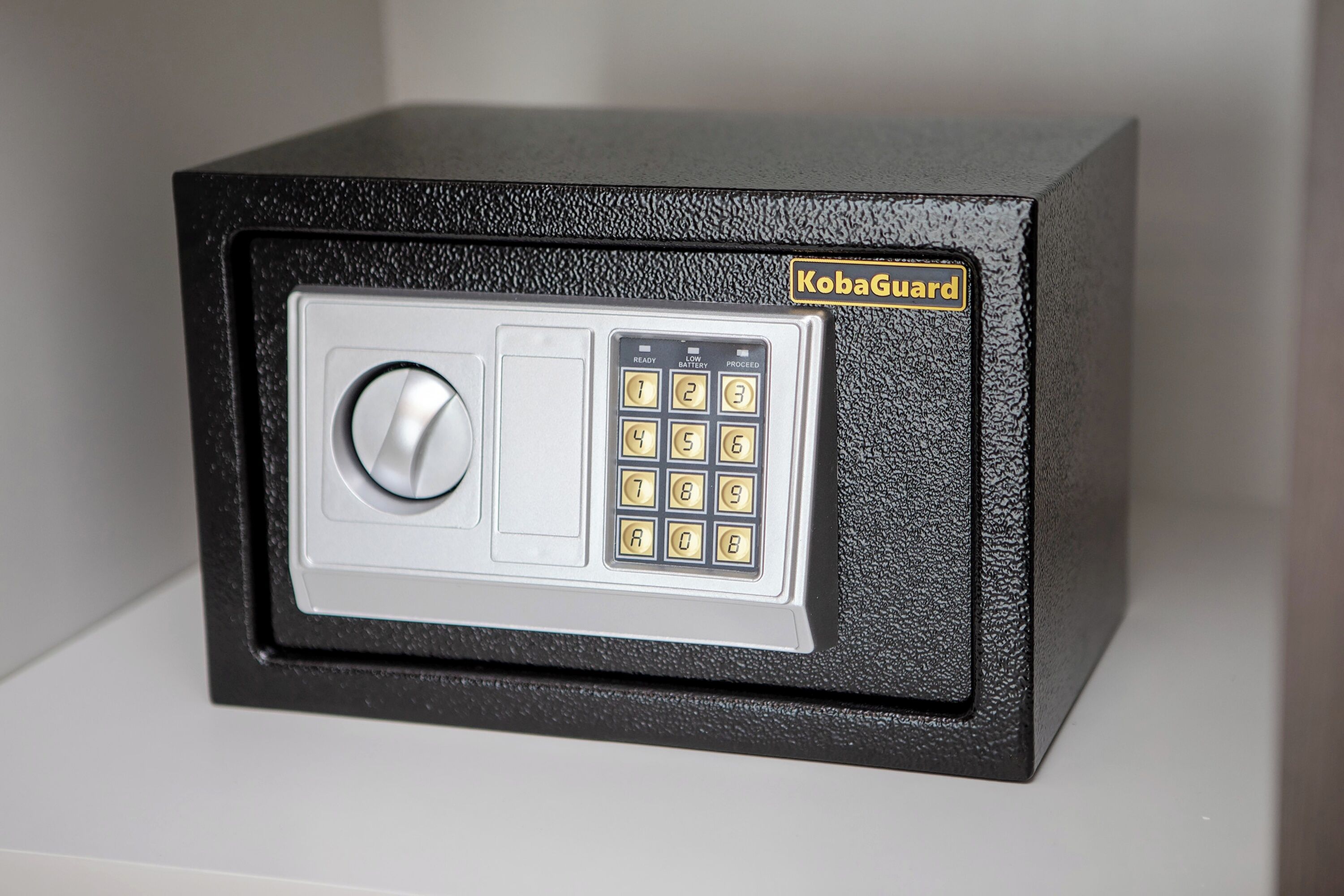 A black safe with a keypad and a dial lock, labeled "KobaGuard."