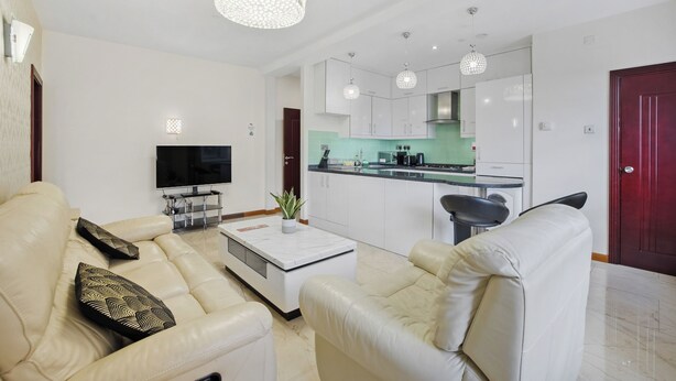 A modern living room with a sofa, coffee table, and TV. - Luxury Mayflower Apartment, Central City Centre, Newly Refurbished (Plymouth)