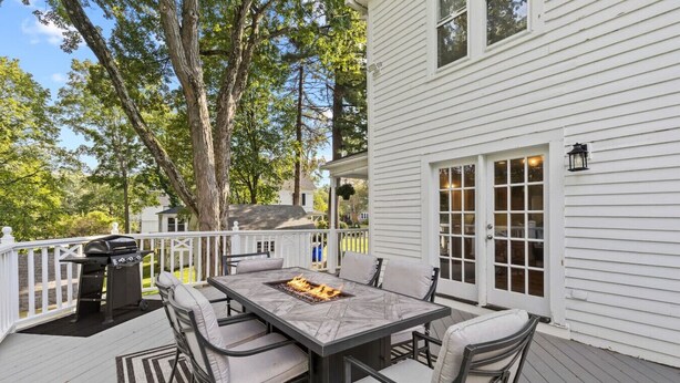 A covered patio with a dining table, chairs, and a grill. - Prime West Hartford Center Location: Historic Gem (West Hartford)