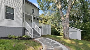 A two-story house with a stone pathway leading to a wooden staircase. - Prime West Hartford Center Location: Historic Gem (West Hartford)