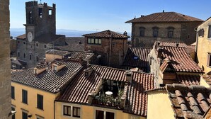 A historic town with traditional architecture, including a prominent tower and a building with a clock.