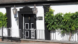 A white building with a black door, two street lamps, and a sign reading "Eagle House". - Eagle House- Award Winning B&B and Apartment (Stafford)