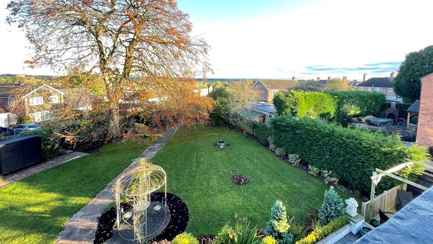 A well-maintained garden with a lawn, a decorative metal structure, and a large tree. - Eagle House- Award Winning B&B and Apartment (Stafford)