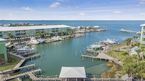 A marina with boats docked, a covered pavilion, and a building with a green roof. - Best View in Ft Morgan | Relaxing Retreat w Pool - Boat Slips + Hot Tub (Gulf Shores)