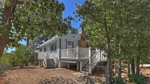 A two-story house with a covered porch and a staircase leading to the upper level. - Inyo Happy Place I Game Room + Fireplace (Sugarloaf)