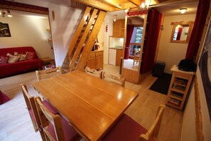 Relax in this inviting space with a dining table and comfortable seating area.
