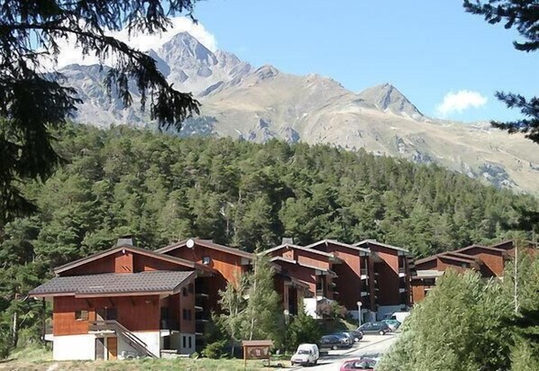 Experience serene mountain views from the balcony of each cabin, nestled among the forest.