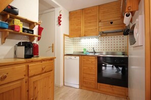 Kitchen equipped with a sink, dishwasher, and coffee maker.